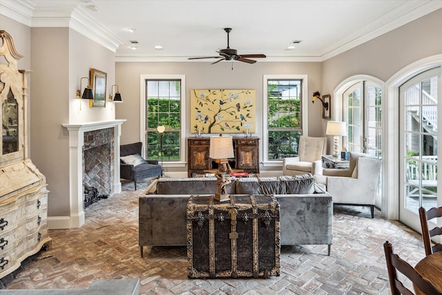living area featuring ceiling fan, brick floors, a fireplace, crown molding, and recessed lighting