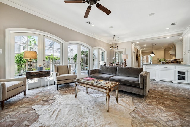 living area featuring brick flooring, ceiling fan, crown molding, and recessed lighting