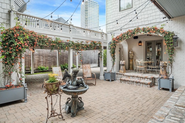 view of patio with french doors and fence