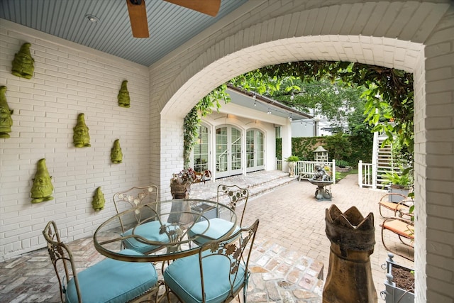 view of patio / terrace featuring outdoor dining space, french doors, and ceiling fan