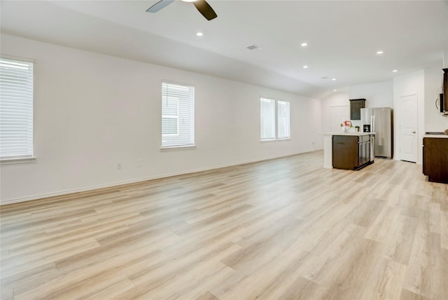 12319 Tranquil Pines Dr, Houston, TX 77014 - unfurnished living room featuring light wood finished floors, ceiling fan, recessed lighting, and vaulted ceiling