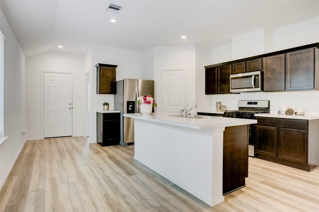 12319 Tranquil Pines Dr, Houston, TX 77014 - kitchen featuring appliances with stainless steel finishes, a sink, light wood finished floors, dark brown cabinetry, and light countertops