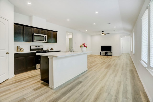 12319 Tranquil Pines Dr, Houston, TX 77014 - kitchen featuring stainless steel appliances, light wood finished floors, light countertops, a ceiling fan, and recessed lighting