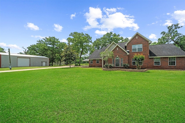 996 Scroggins Ln, Waller, TX 77484 - view of front facade with a front lawn, brick siding, concrete driveway, and an outdoor structure