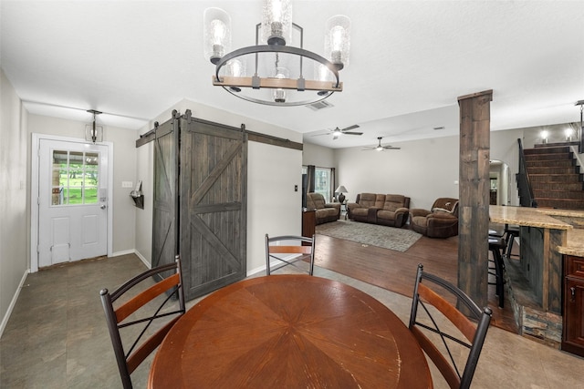 996 Scroggins Ln, Waller, TX 77484 - dining room featuring a barn door, baseboards, a ceiling fan, stairs, and a chandelier