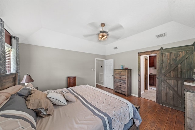 996 Scroggins Ln, Waller, TX 77484 - bedroom with wood-type flooring, a barn door, lofted ceiling, and ceiling fan