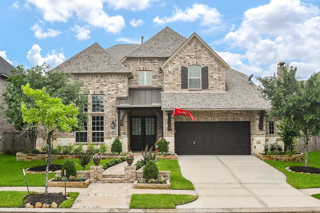 french country home with french doors, a shingled roof, brick siding, concrete driveway, and a garage