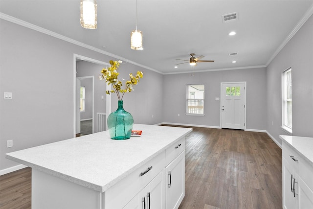 kitchen featuring light countertops, ceiling fan, dark wood-style flooring, ornamental molding, and white cabinets