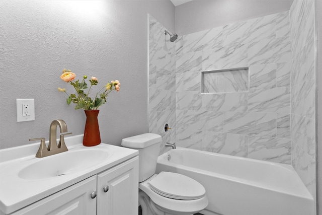bathroom featuring toilet, shower / bathtub combination, vanity, and a textured wall