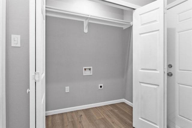 washroom with hookup for an electric dryer, washer hookup, wood finished floors, and baseboards