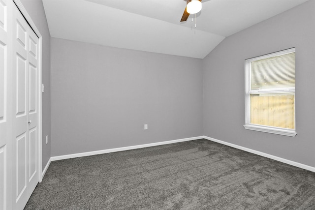 unfurnished bedroom with a closet, carpet, vaulted ceiling, and baseboards
