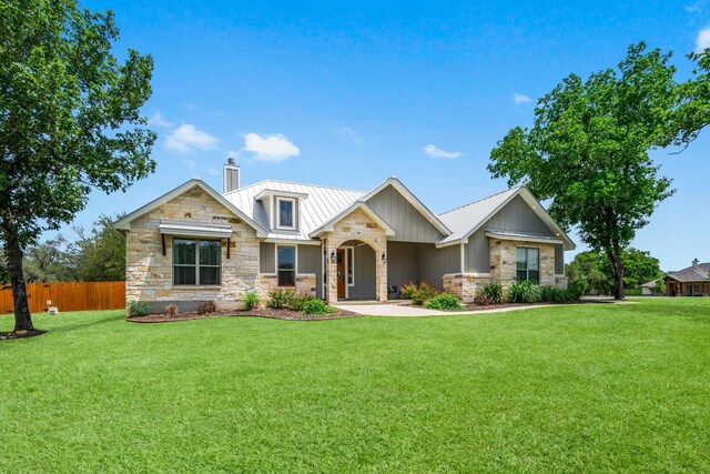 100 Calvary Dr, Adkins, TX 78101 - craftsman-style house featuring stone siding, a chimney, a standing seam roof, and metal roof