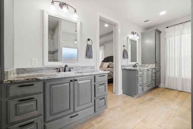 100 Calvary Dr, Adkins, TX 78101 - full bathroom with two vanities, connected bathroom, and curtained shower