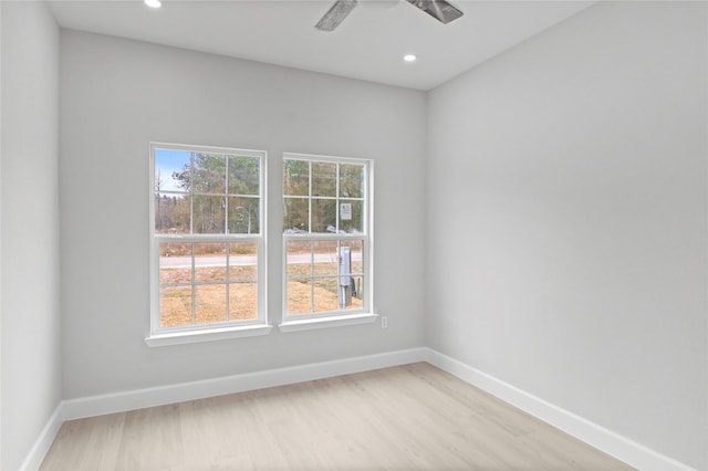 spare room featuring light wood-type flooring, baseboards, recessed lighting, and ceiling fan