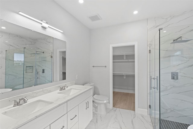 bathroom featuring marble look tiles, a marble finish shower, a spacious closet, recessed lighting, and double vanity