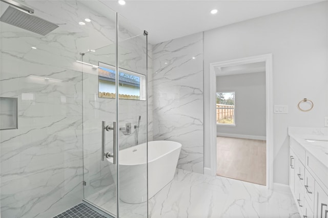 bathroom featuring a marble finish shower, marble finish flooring, recessed lighting, vanity, and a soaking tub