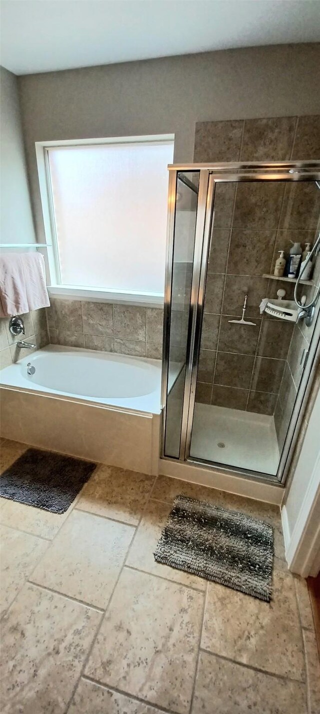full bath with a shower stall and a bath