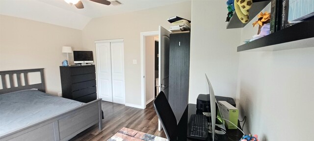 bedroom with wood finished floors, lofted ceiling, a closet, ceiling fan, and a desk
