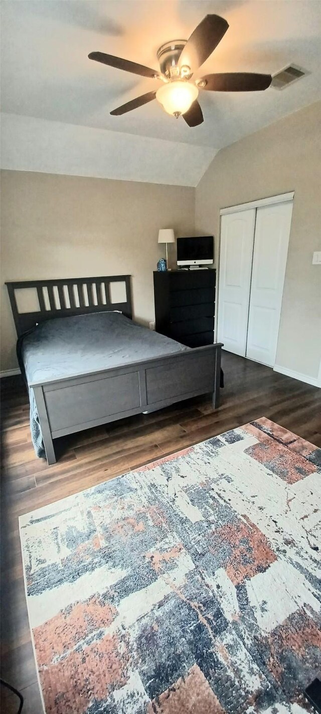 bedroom with dark wood finished floors, baseboards, a ceiling fan, and vaulted ceiling