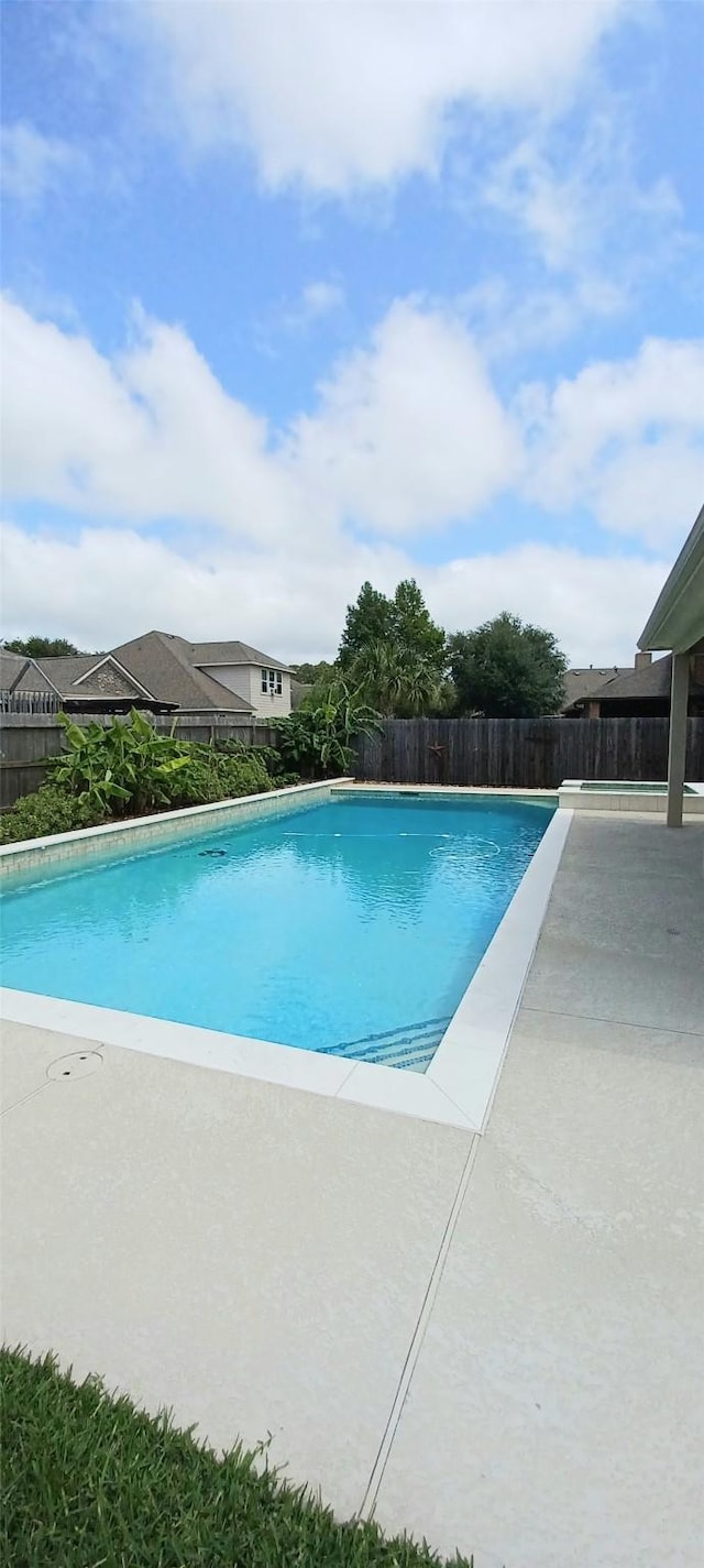 view of swimming pool featuring a fenced backyard and a patio area