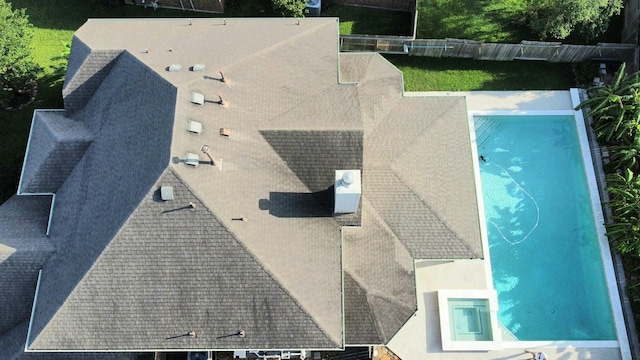 aerial view of property and surrounding area with a pool area