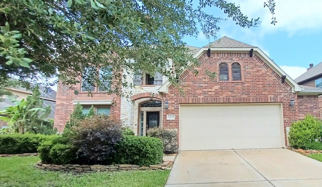 view of front facade with brick siding, concrete driveway, a garage, and a shingled roof