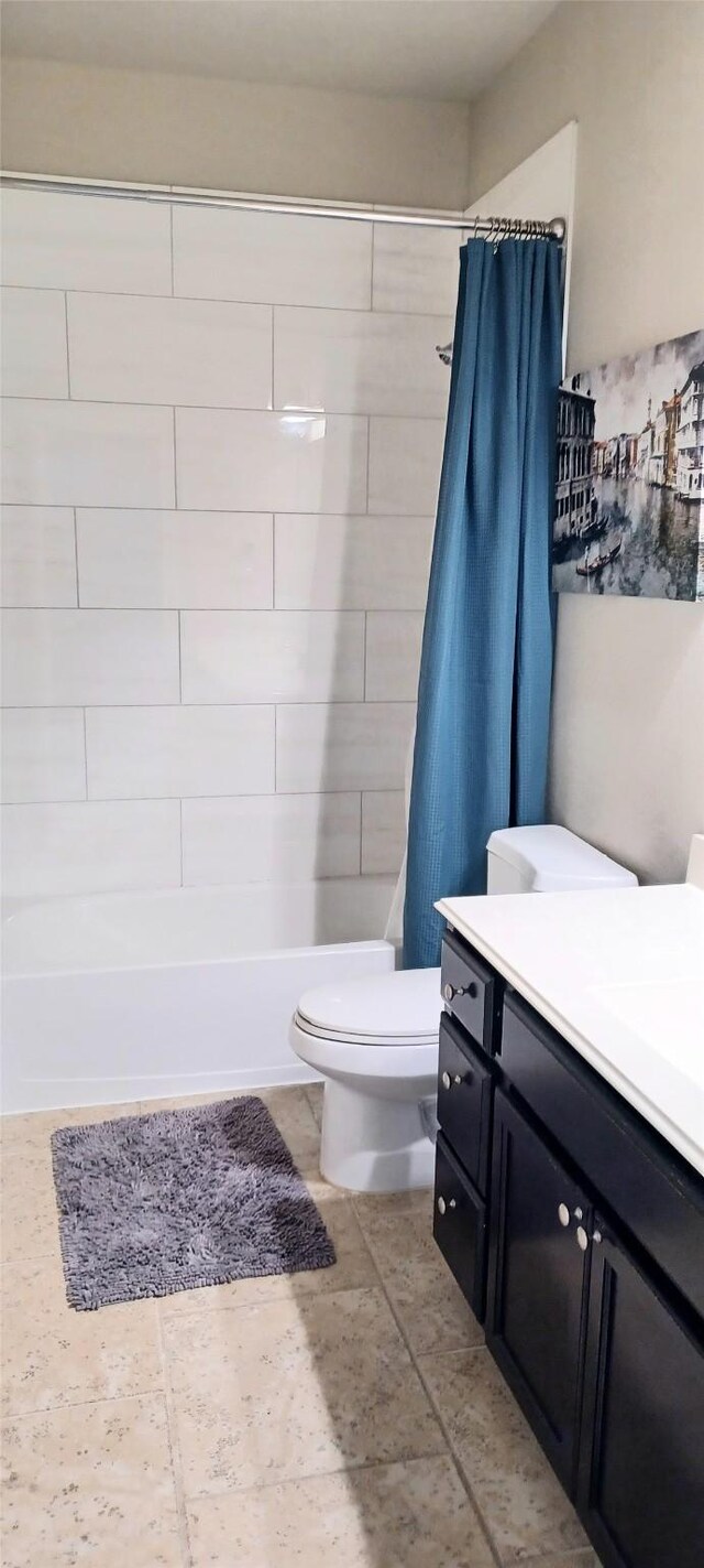 bathroom with toilet, shower / bathtub combination with curtain, and vanity