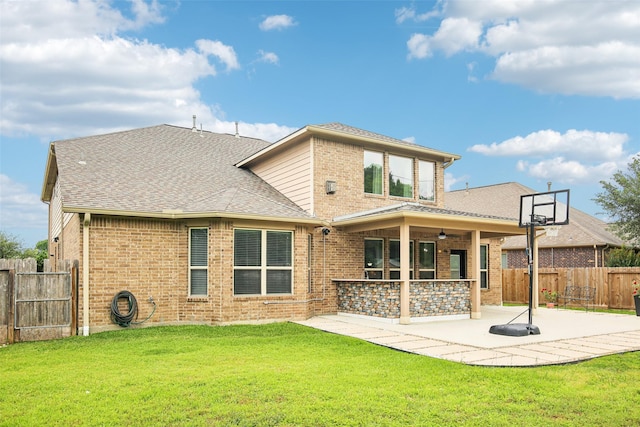 back of property with a patio area, brick siding, a shingled roof, and a ceiling fan
