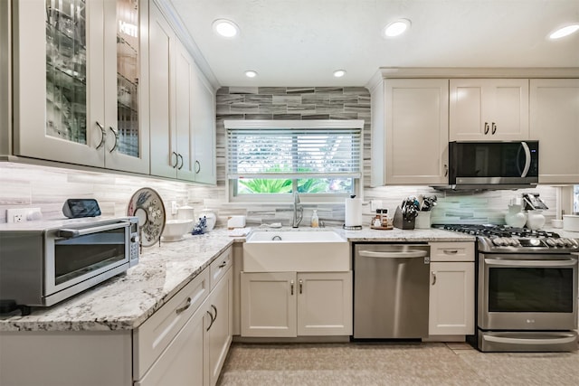 15223 Hillside Park Way, Cypress, TX 77433 - kitchen with stainless steel appliances, a sink, decorative backsplash, recessed lighting, and glass insert cabinets