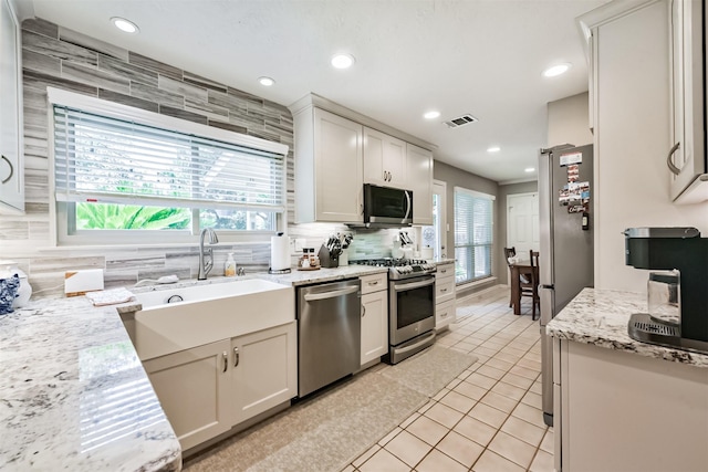 15223 Hillside Park Way, Cypress, TX 77433 - kitchen with stainless steel appliances, a sink, backsplash, recessed lighting, and light tile patterned floors