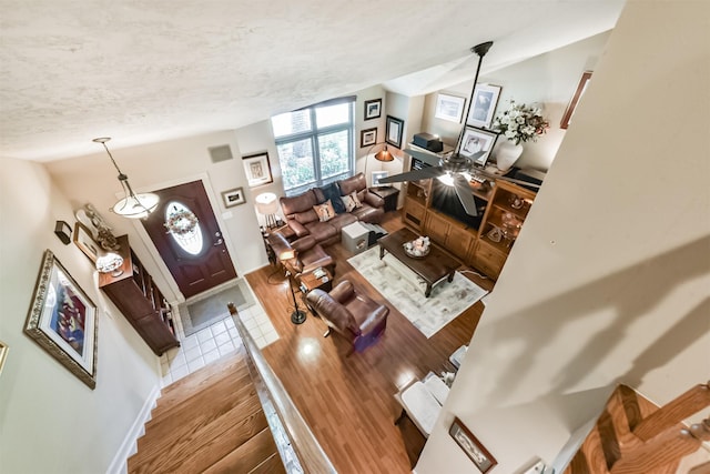 15223 Hillside Park Way, Cypress, TX 77433 - living area with a textured ceiling, wood finished floors, baseboards, and lofted ceiling
