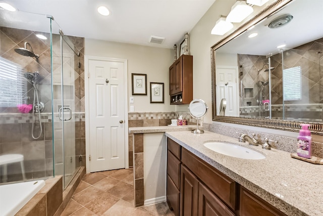15223 Hillside Park Way, Cypress, TX 77433 - bathroom featuring a stall shower, vanity, tile patterned flooring, tile walls, and recessed lighting