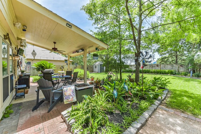 15223 Hillside Park Way, Cypress, TX 77433 - view of patio / terrace with a shed, ceiling fan, outdoor dining space, and an outbuilding