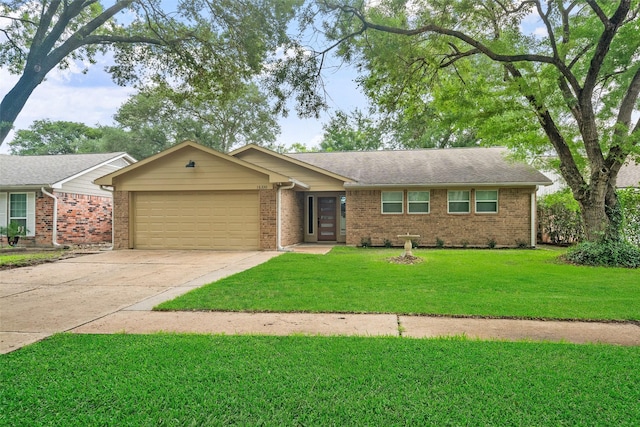 16330 Autumn Wind Dr, Houston, TX 77090 - ranch-style home featuring an attached garage, concrete driveway, brick siding, and a front lawn