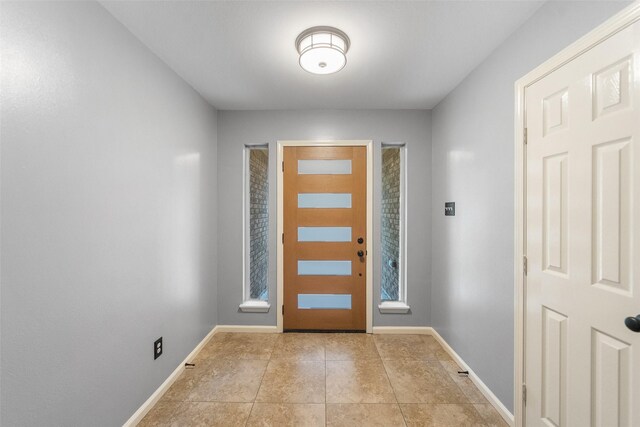 16330 Autumn Wind Dr, Houston, TX 77090 - foyer entrance with light tile patterned floors and baseboards