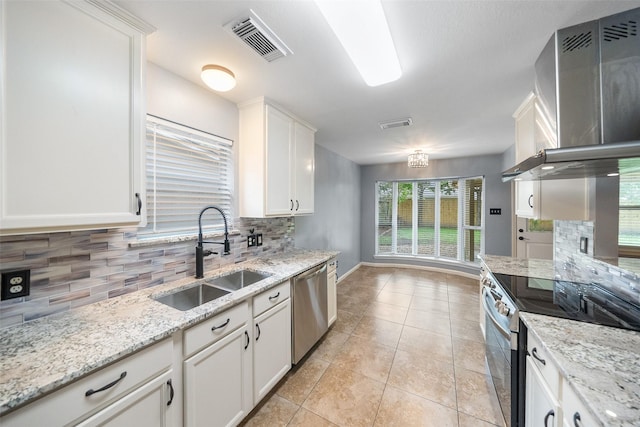 16330 Autumn Wind Dr, Houston, TX 77090 - kitchen with stainless steel appliances, a sink, range hood, decorative backsplash, and white cabinetry