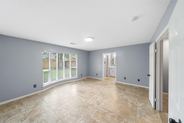 16330 Autumn Wind Dr, Houston, TX 77090 - spare room featuring baseboards, a smoke detector, and light tile patterned flooring