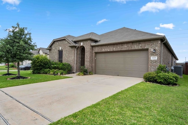 15335 Oakheath Colony Ln, Houston, TX 77044 - view of front of home featuring brick siding, central AC unit, a garage, driveway, and a front yard