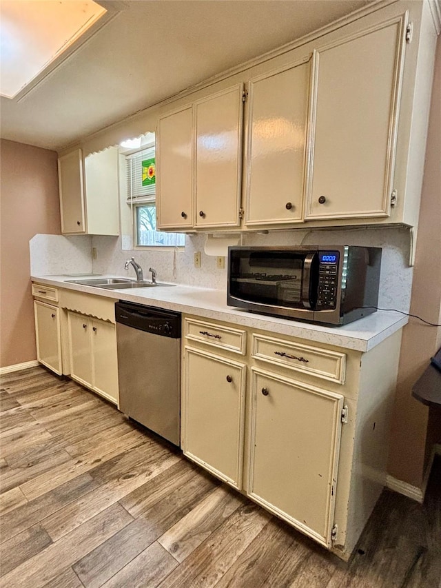 13642 Greenridge Dr, Sugar Land, TX 77498 - kitchen featuring stainless steel dishwasher, a sink, and light wood-type flooring