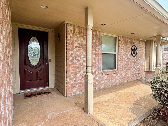 13642 Greenridge Dr, Sugar Land, TX 77498 - view of exterior entry featuring brick siding and a porch