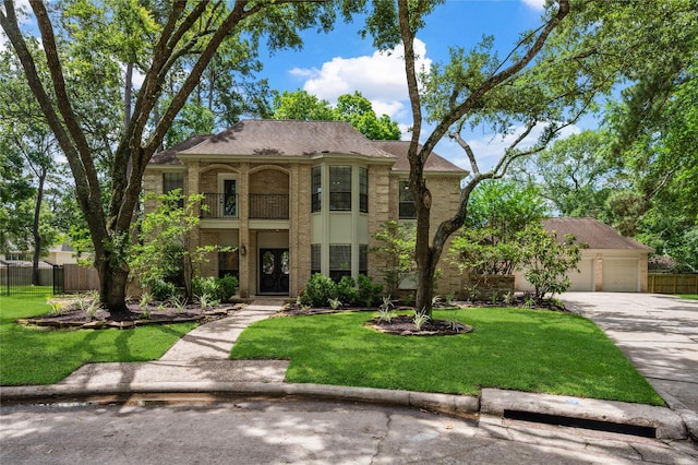 view of front of property featuring a balcony, concrete driveway, and a garage