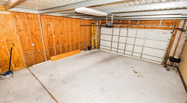 11905 Algonquin Dr Unit 10, Houston, TX 77089 - garage featuring a garage door opener and wooden walls