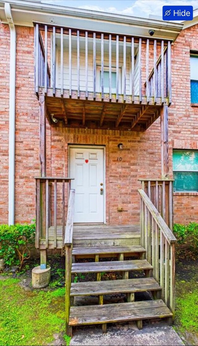 11905 Algonquin Dr Unit 10, Houston, TX 77089 - view of exterior entry featuring brick siding and a balcony