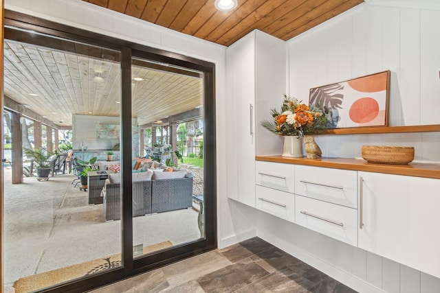 doorway featuring wood ceiling, healthy amount of natural light, and recessed lighting