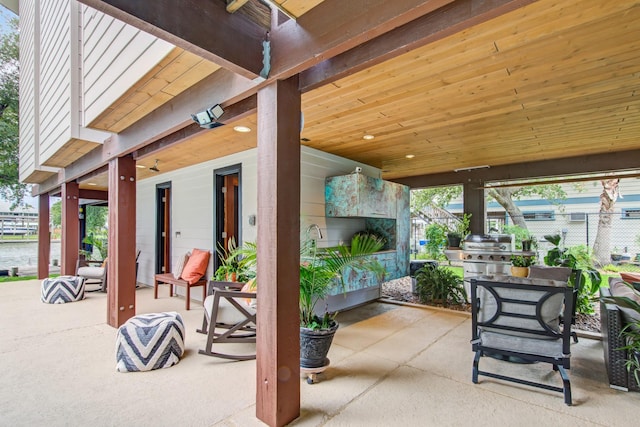 view of patio / terrace featuring fence and exterior kitchen