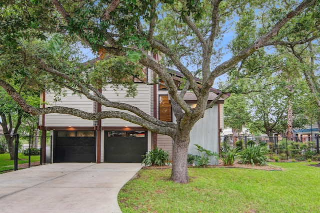 view of front of property with a garage, driveway, and a carport