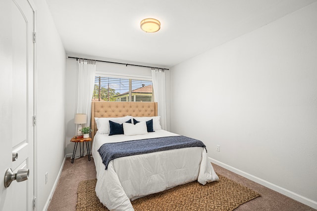 bedroom with carpet flooring and baseboards
