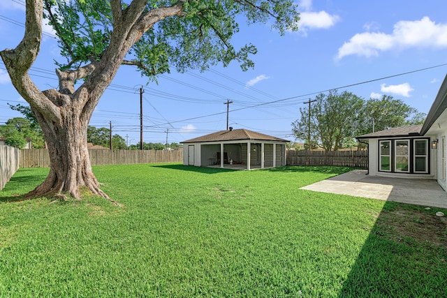 view of yard featuring a patio area and an outdoor structure
