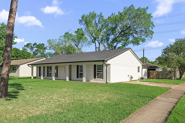 ranch-style house with a porch, brick siding, and roof with shingles