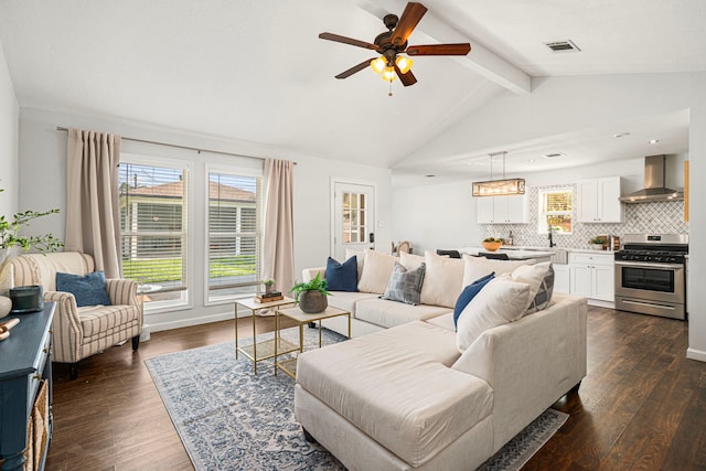 living area featuring ceiling fan and dark wood finished floors